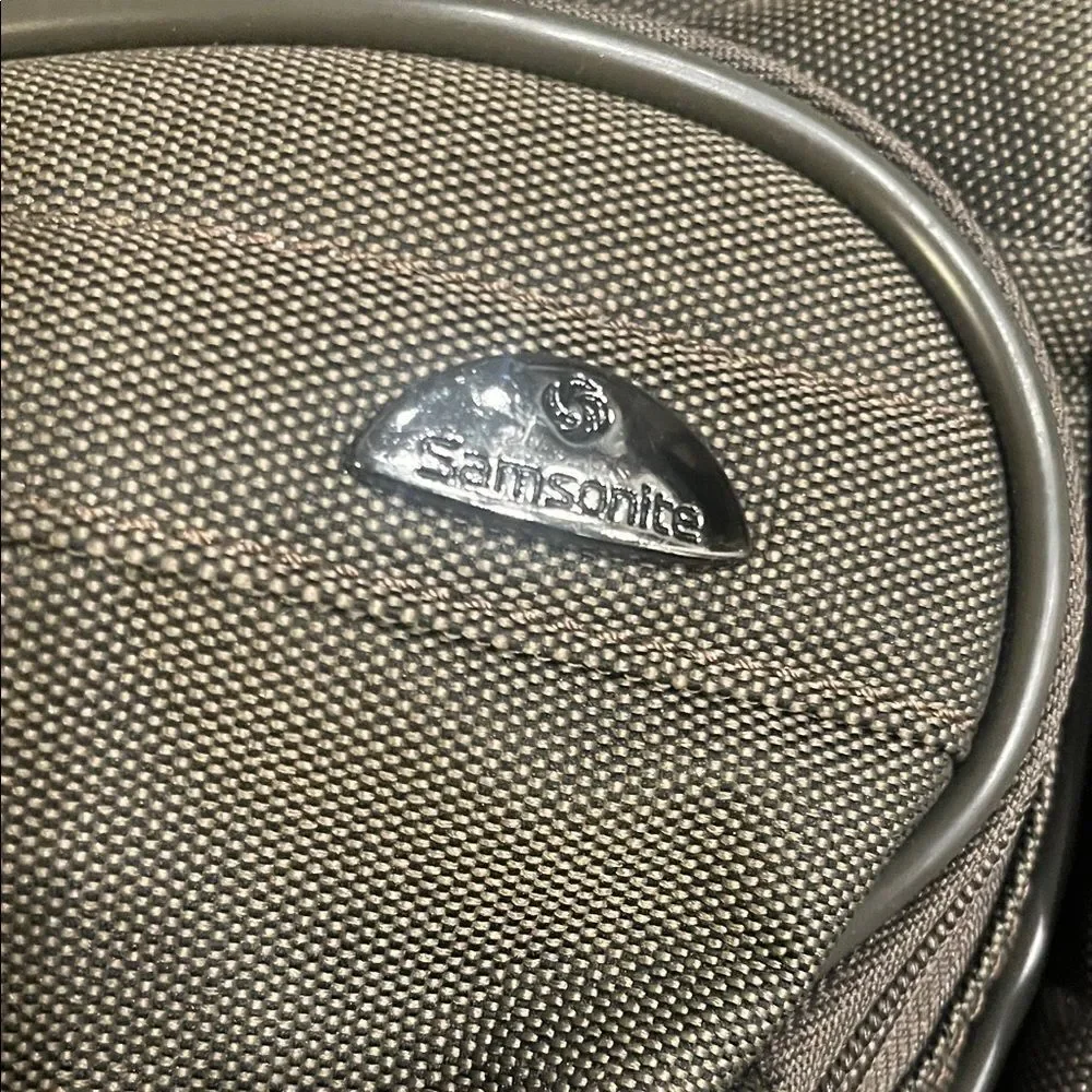 Samsonite army green Bag fits on luggage. 15”x 12”x 19” adjustable strap